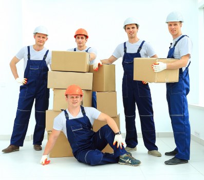 House removal team loading furniture into a moving van