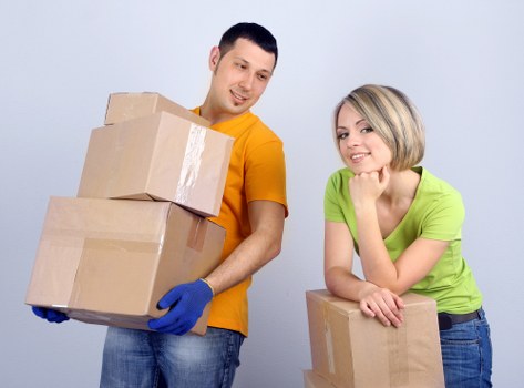 Packed moving boxes and furniture prepared for a home move in Watford