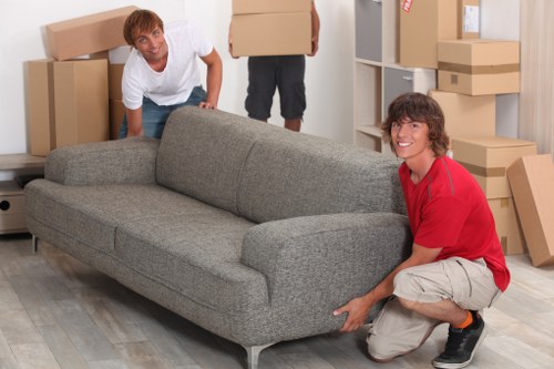 Professional movers carrying furniture into a home