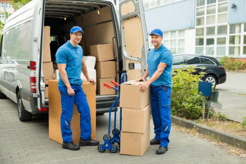 Local furniture collection team handling a sofa and chair in Watford