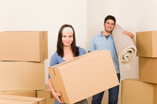 Removal team handling bulky furniture in Watford home move