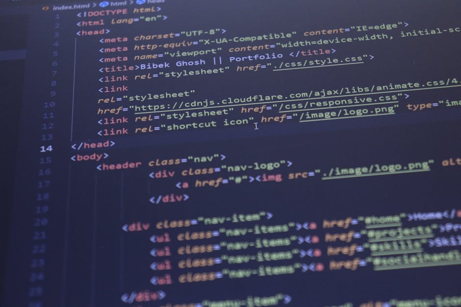 A person working at a desk, seen from the back, is handling a laptop with a screen displaying lines of colorful code, indicating programming or software development related to house removals and movin